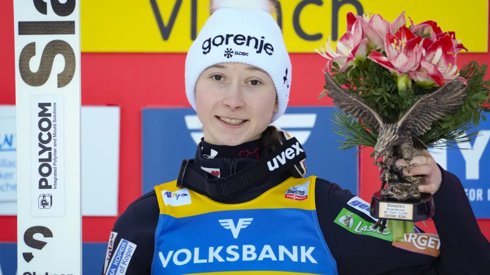 Gold medal winner Slovenia's Nika Prevc poses on the podium at the Women Normal Hill Individual Ski Jumping World Cup event in Villach, Austria, Thursday, Jan. 4, 2024. (AP Photo/Darko Bandic)