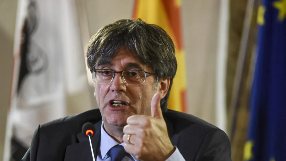 ADDS SECOND SENTENCE. <br>FILE - Catalan leader Carles Puigdemont speaks at a press conference in Alghero, Sardinia, Italy, Oct. 4, 2021. Puigdemont says that he will return to Spain for the first time since leading a failed 2017 breakaway bid if he has a viable chance to be restored as regional president following upcoming elections. Puigdemont is still a wanted man in Spain and hoping that a contentious amnesty bill that was crafted by Spain's left-wing government to clear him and hundreds of other supporters successfully makes it through the Madrid parliament in the coming months. (AP Photo/Gloria Calvi, File)