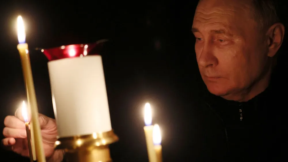 Russian President Vladimir Putin lights a candle in memory of the victims of the Crocus City Hall attack, on the day of national mourning in a church at the Novo-Ogaryovo state residence outside Moscow, Russia March 24, 2024. Sputnik/Mikhail Metzel/Pool via REUTERS ATTENTION EDITORS - THIS IMAGE WAS PROVIDED BY A THIRD PARTY.