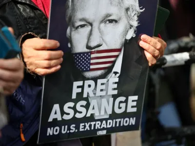A supporter of WikiLeaks founder Julian Assange holds a sign, on the day the High Court is set to rule on whether Julian Assange can appeal against extradition from Britain to the United States, in London, Britain, March 26, 2024. REUTERS/Toby Melville