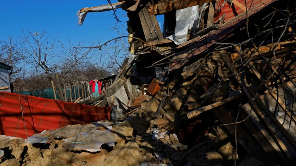 Local resident Svetlana stands on the ruins of her house, which was destroyed, according to Russian-installed authorities, by a Ukrainian military strike in the course of Russia-Ukraine conflict, in the town of Vuhlehirsk (Uglegorsk) in the Donetsk Region, Russian-controlled Ukraine, March 28, 2024. REUTERS/Alexander Ermochenko