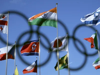 The North Korean flag, left center, flies amongst flags from many nations as they fly at the Olympic Village at the 2018 Winter Olympics in Gangneung, South Korea, Thursday, Feb. 1, 2018. (AP Photo/Charlie Riedel)