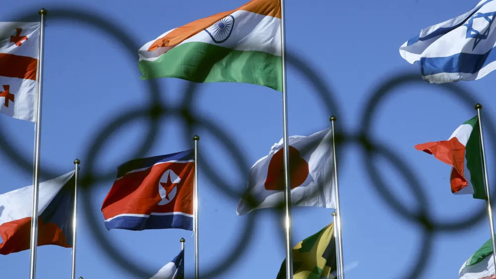The North Korean flag, left center, flies amongst flags from many nations as they fly at the Olympic Village at the 2018 Winter Olympics in Gangneung, South Korea, Thursday, Feb. 1, 2018. (AP Photo/Charlie Riedel)
