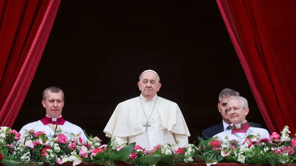 Pope Francis stands on a balcony, on the day he delivers his "Urbi et Orbi" (To the city and the world) message at St. Peter's Square, on Easter Sunday, at the Vatican March 31, 2024. REUTERS/Yara Nardi