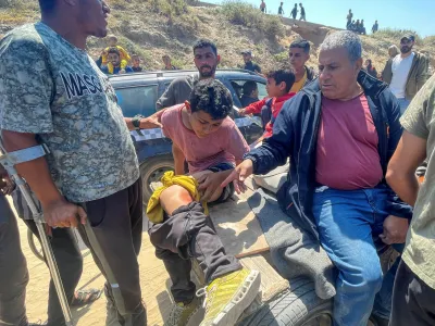 A Palestinian boy, who was displaced by Israel's military offensive on south Gaza, is helped after he got wounded while attempting to return to his home in north Gaza, amid the ongoing conflict between Israel and Hamas, as seen from central Gaza Strip April 14, 2024. REUTERS/Ramadan Abed