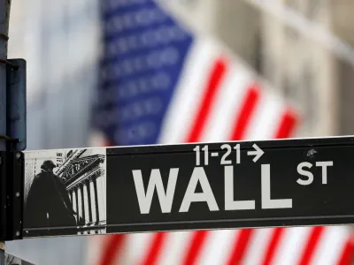FILE PHOTO: A street sign for Wall Street is seen outside the New York Stock Exchange (NYSE) in New York City, New York, U.S., July 19, 2021. REUTERS/Andrew Kelly/File Photo