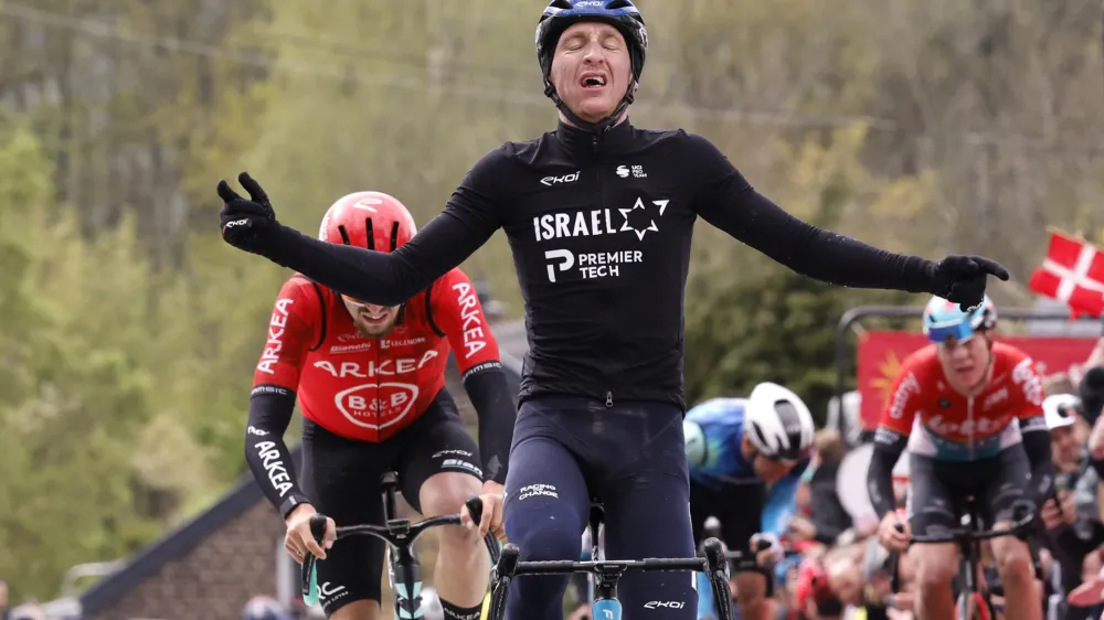 United Kingdom's Stephen Williams of the Israel First Tech team crosses the finish line to win the Belgian cycling classic and UCI World Tour race Fleche Wallonne (Walloon Arrow), in Huy, Belgium, Wednesday, April 17, 2024. (AP Photo/Geert Vanden Wijngaert)