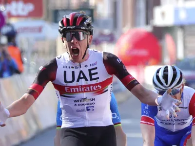 Slovenia's Tadej Pogacar of the UAE team Emirates crosses the finish line to win the Belgian cycling classic and UCI World Tour cycling race Liege Bastogne Liege, in Liege, Belgium, Sunday, April 25, 2021. (AP Photo/Olivier Matthys)