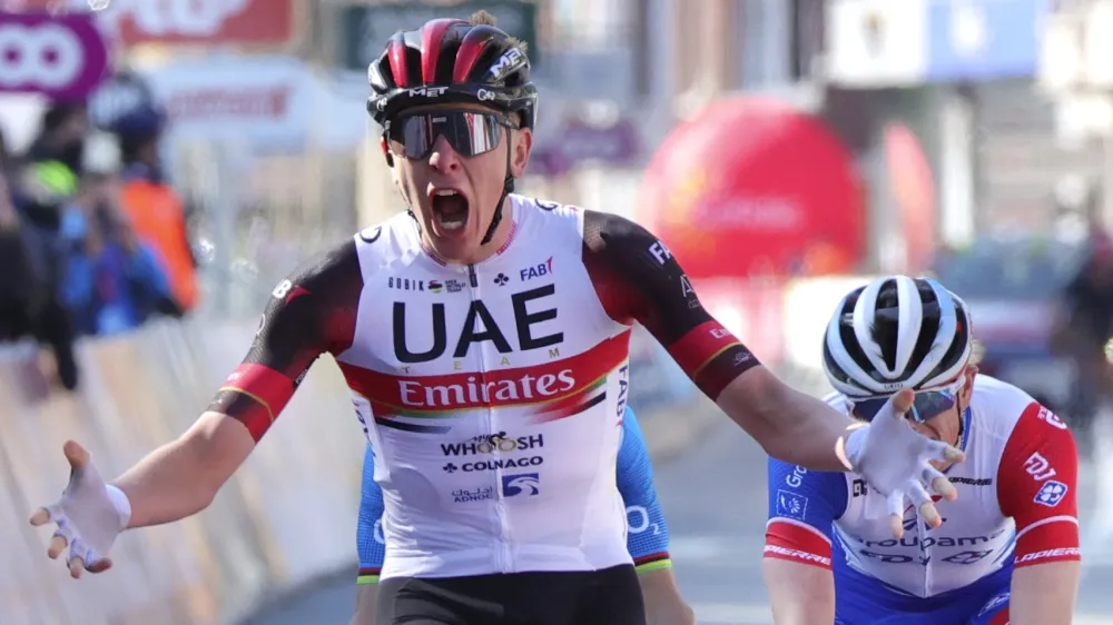 Slovenia's Tadej Pogacar of the UAE team Emirates crosses the finish line to win the Belgian cycling classic and UCI World Tour cycling race Liege Bastogne Liege, in Liege, Belgium, Sunday, April 25, 2021. (AP Photo/Olivier Matthys)