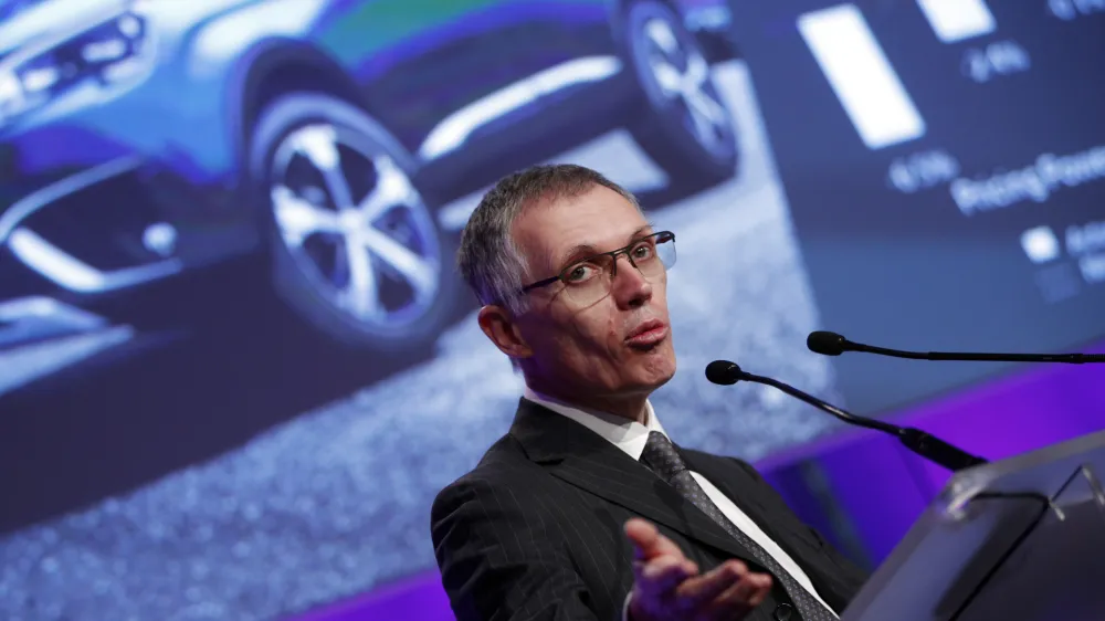 PSA Peugeot Citroen Chief Executive Carlos Tavares delivers his speech during the presentation of the company's 2016 full year results, in Paris, Thursday, Feb.23, 2017. French carmaker PSA Group saw its profits jump last year and is giving dividends for the first time since 2011, burnishing its image as it weighs a buyout of General Motors' money-losing European operations. (AP Photo/Christophe Ena)