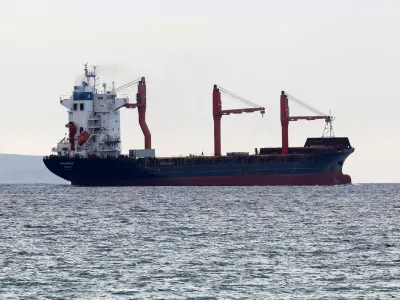 A person is seen on board as a U.S. flagged cargo vessel carrying aid to a pier built by the U.S. off Gaza sets sail from Larnaca, Cyprus May 9, 2024. REUTERS/Yiannis Kourtoglou