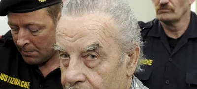 FILE - Josef Fritzl, center, is escorted to the fourth day of his trial in the provincial courthouse in St. Poelten, Austria, Thursday, March 19, 2009. An Austrian court has ruled that the man who kept his daughter captive for 24 years and raped her thousands of times, fathering seven children with her, can be moved from psychiatric detention to a regular prison. The decision follows a legal back-and-forth on Josef Fritzl's future. (AP Photo/Robert Jaeger, Pool, File)