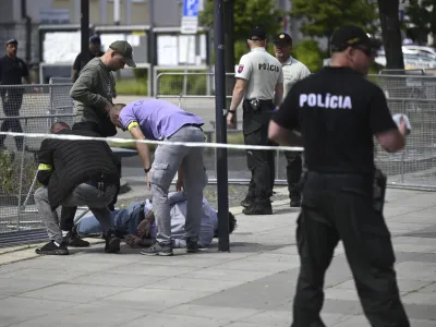 Police arrest a man after Slovak Prime Minister Robert Fico was shot and injured following the cabinet's away-from-home session in the town of Handlova, Slovakia, Wednesday, May 15, 2024. Fico is in life-threatening condition after being wounded in a shooting Wednesday afternoon, according to his Facebook profile. (Radovan Stoklasa/TASR via AP)