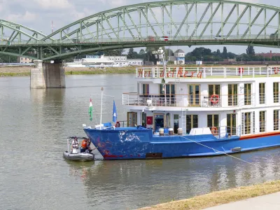 Police investigators examine the bow of a river cruise ship after an incident, in Komarom, Hungary, Sunday, May 19, 2024. Police say two people have died and five are missing following a boat collision on the Danube River in Hungary. Hungarian police received a report late Saturday night that a man had been found with a head injury on the shore of the Danube near the town of Veroce, around 30 miles (50 kilometers) north of the capital, Budapest. (Peter Lakatos/MTI via AP)
