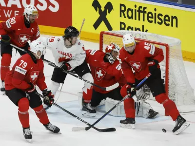 Ice Hockey - IIHF World Championships - Group A - Switzerland v Canada - Prague Arena, Prague, Czech Republic - May 19, 2024 Canada's Jared McCann in action with Switzerland's Leonardo Genoni and Michael Fora REUTERS/Eva Korinkova