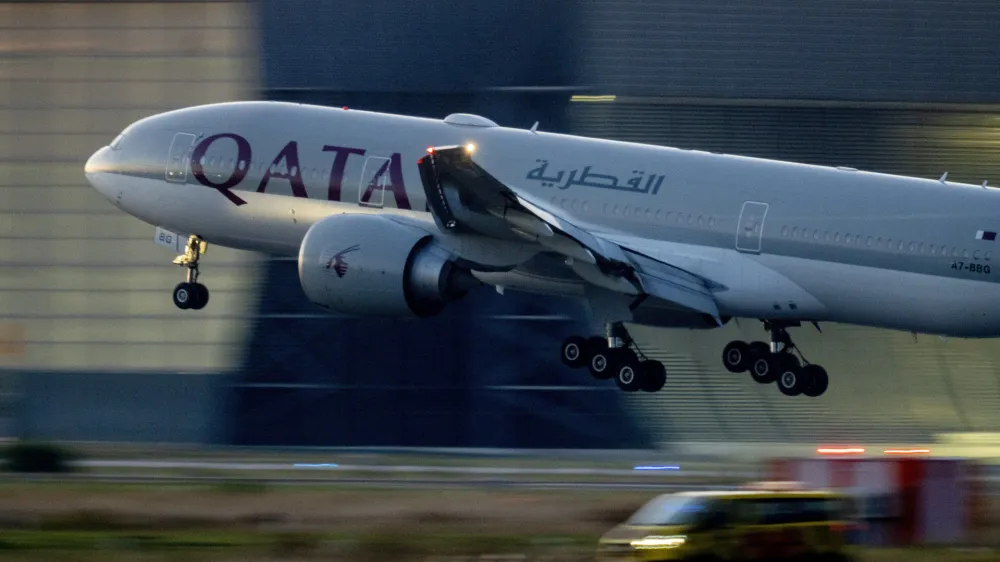 FILE - A Qatar airways plane lands at the airport in Frankfurt, Germany, as the sun rises on Sept. 25, 2023. Twelve people were injured when a Qatar Airways plane flying from Doha to Dublin on Sunday May 26, 2024 hit turbulence, airport authorities said. (AP Photo/Michael Probst, File)