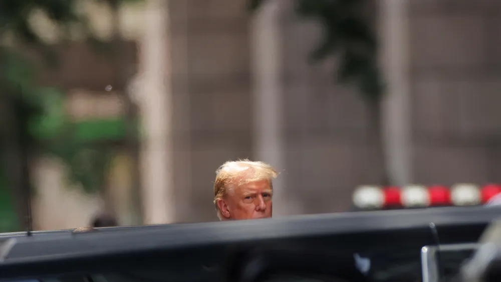 Republican presidential candidate and former U.S. President Donald Trump looks on outside Trump Tower, the day after a guilty verdict in his criminal trial over charges that he falsified business records to conceal money paid to silence porn star Stormy Daniels in 2016, in New York City, U.S., May 31, 2024. REUTERS/Andrew Kelly