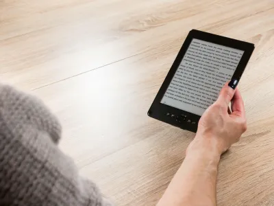 HTC209 Woman holding ebook reader in front of the table