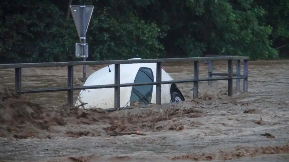 09 June 2024, Austria, Sch&auml;ffern: A car submerged in water as torrential rainfall once again caused numerous floods early 09 June in Austria. Photo: Einsatzdoku.At Patrik Lechner/APA/dpa