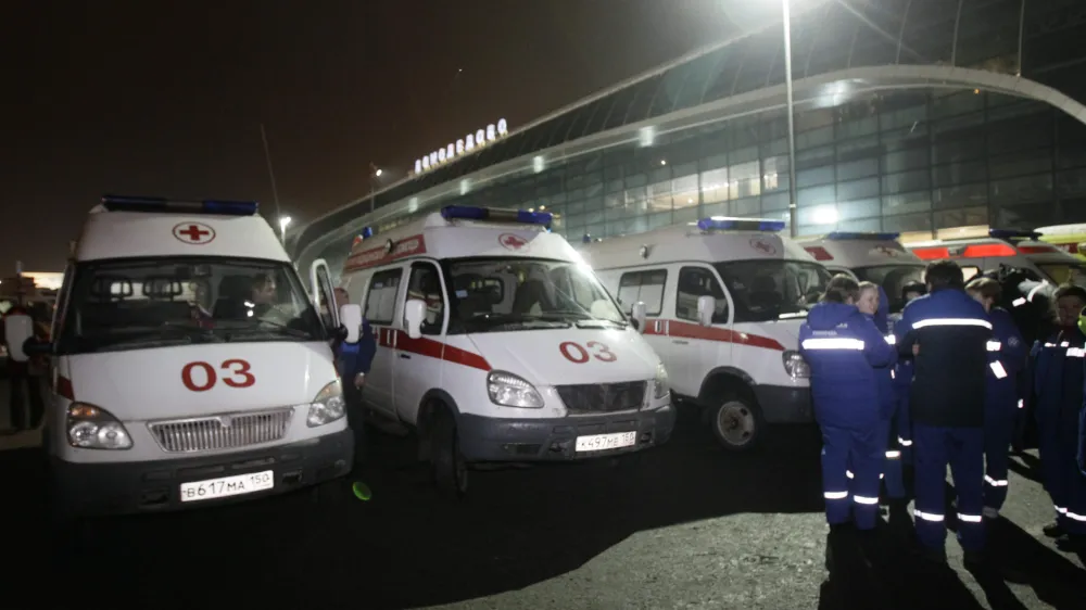 Ambulances are seen outside a terminal at Domodedovo airport, Moscow, Monday, Jan. 24, 2011. An explosion ripped through the international arrivals hall at Moscow's busiest airport on Monday, killing dozens of people and wounding scores, officials said. The Russian president called it a terror attack. (AP Photo/Ivan Sekretarev)