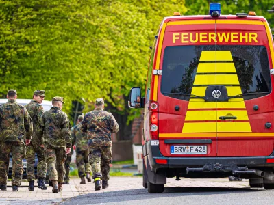 FILED - 27 April 2024, Lower Saxony, Elm: Soldiers of the German Armed Forces walk along a street in a residential area, past a fire department vehicle during the search operation for Arian a missing six-year-old child in northern Lower Saxony. A body found in the German state of Lower Saxony was on 27 June confirmed as that of Arian's, police said.There were no indications of foul play, investigators said. They&nbsp;did not reveal the cause of death to protect the family. Photo: Moritz Frankenberg/dpa