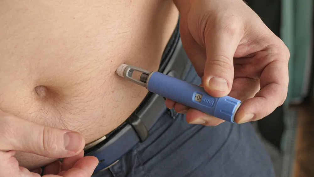 obese fat man injecting Semaglutide Ozempic injection control blood sugar levels