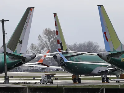 FILE- In this Nov. 14, 2018, file photo Boeing 737 MAX 8 planes are parked near Boeing Co.'s 737 assembly facility in Renton, Wash. Investigators were rushing to the scene of a devastating plane crash in Ethiopia on Sunday, March 10, 2019, an accident that could renew safety questions about the newest version of Boeing's popular 737 airliner. (AP Photo/Ted S. Warren, File)