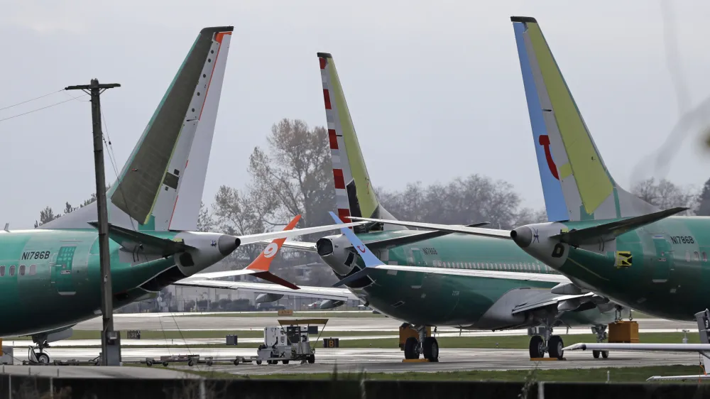 FILE- In this Nov. 14, 2018, file photo Boeing 737 MAX 8 planes are parked near Boeing Co.'s 737 assembly facility in Renton, Wash. Investigators were rushing to the scene of a devastating plane crash in Ethiopia on Sunday, March 10, 2019, an accident that could renew safety questions about the newest version of Boeing's popular 737 airliner. (AP Photo/Ted S. Warren, File)
