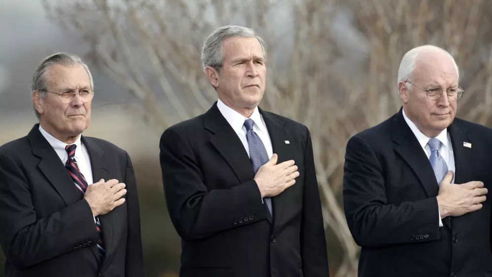 U.S. President George W. Bush, Vice President Dick Cheney (R) and outgoing Secretary of Defense Donald Rumsfeld (L) place their hands over their hearts as the national anthem is played at Rumsfeld's farewell tribute at the Pentagon in Arlington, Virginia, December 15, 2006. Rumsfeld will be replaced by former CIA director Robert Gates.  REUTERS/Kevin Lamarque (UNITED STATES)