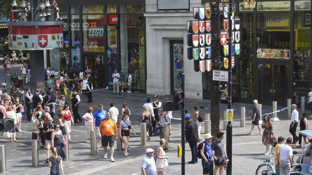 Police cordon off an area in Leicester Square, as a man was arrested with the accusation of stabbing an 11-year-old girl and 34-year-old woman, in London, Monday Aug. 12, 2024. (James Manning/PA via AP)