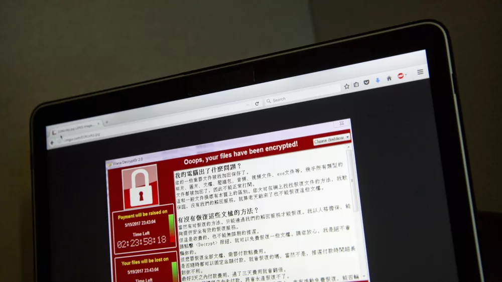 A screenshot of the warning screen from a purported ransomware attack, as captured by a computer user in Taiwan, is seen on laptop in Beijing, Saturday, May 13, 2017. Dozens of countries were hit with a huge cyberextortion attack Friday that locked up computers and held users' files for ransom at a multitude of hospitals, companies and government agencies. (AP Photo/Mark Schiefelbein)