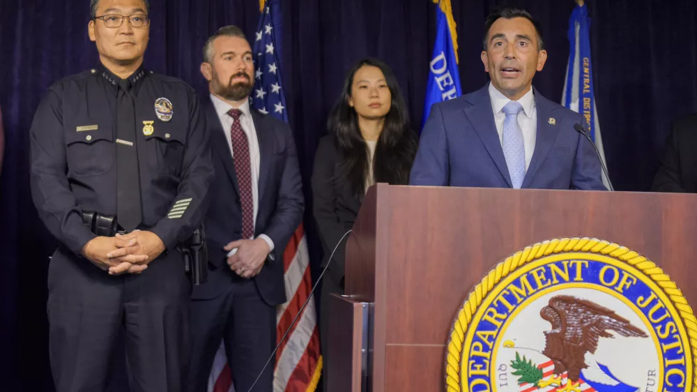 United States Attorney Martin Estrada, at podium, is joined by Los Angeles Police Chief Dominic Choi, far left, and other officials to announce court filings related to the death of actor Matthew Perry in Los Angeles on Thursday, Aug. 15, 2024. (AP Photo/Damian Dovarganes)