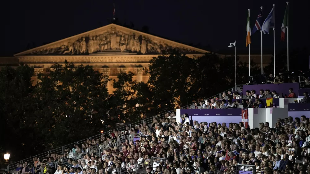 Spectators watch the Opening Ceremony for the 2024 Paralympics, Thursday, Aug. 29, 2024, in Paris, France. (AP Photo/Aurelien Morissard)