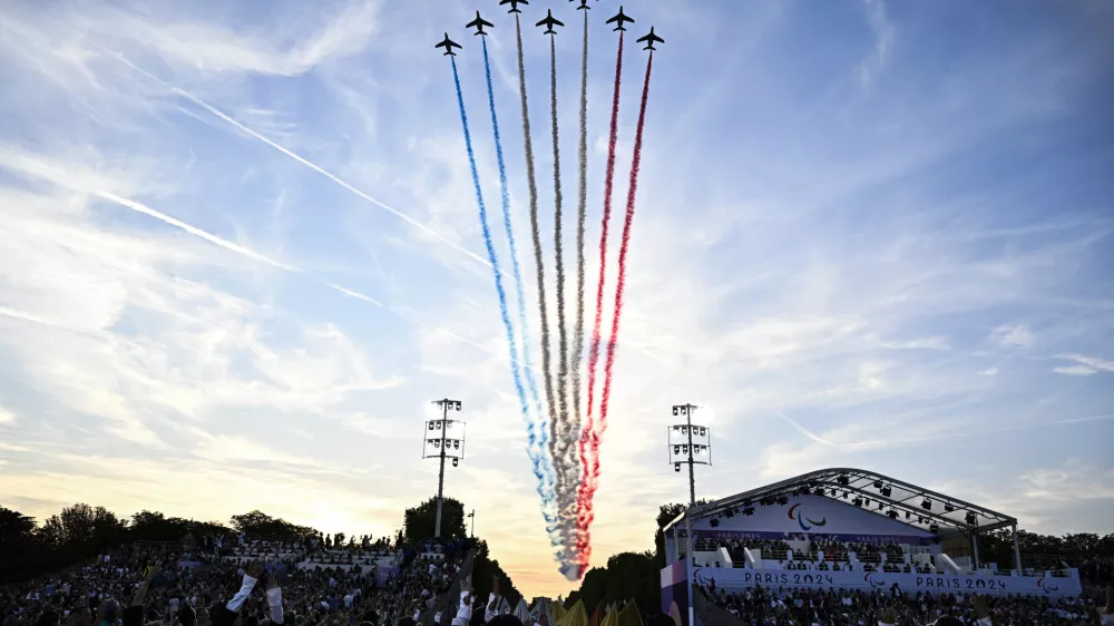 The Patrouille de France fly over the Place de la Concorde during the Paris 2024 Paralympic Games Opening Ceremony in Paris, France, Wednesday Aug. 28, 2024. (Julien De Rosa/Pool Photo via AP)