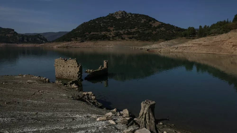 The reappearing remains of buildings of the village of Kallio, which was intentionally flooded in 1980 to create a reservoir that would help meet the water needs of Greek capital Athens, are seen following receding water levels caused by drought, in Lake Mornos, Greece, September 3, 2024. REUTERS/Stelios Misinas