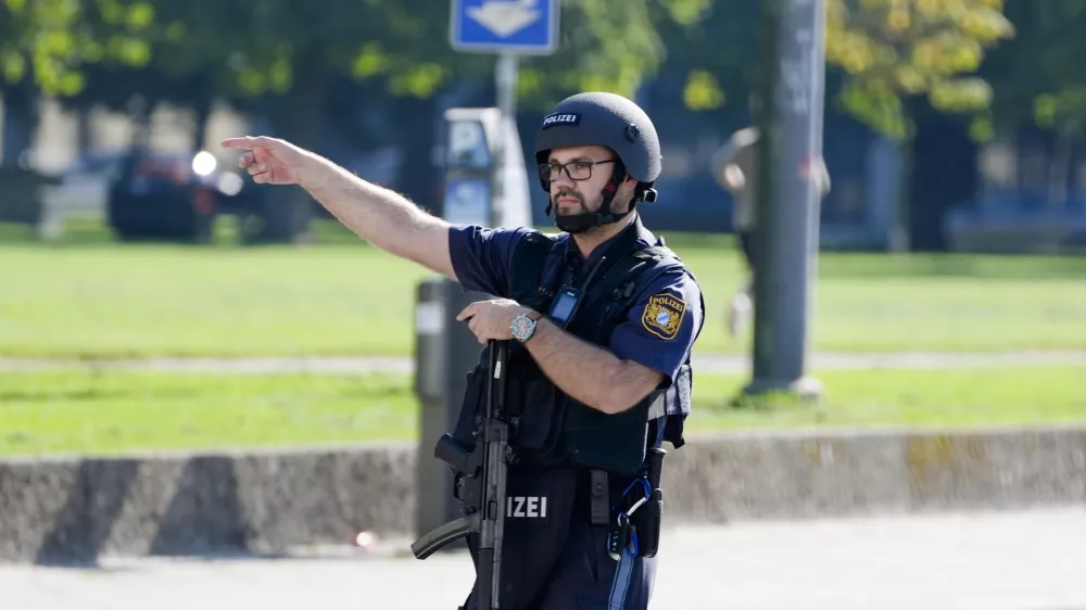 A police officer patrols after police fired shots at a suspicious person near the Israeli Consulate and a museum on the city's Nazi-era history in Munich, Germany, Thursday, Sept. 5, 2024. (AP Photo/Matthias Schrader)