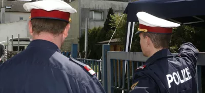 Two policemen are seen at the backyard entrance of a house that was the scene of a crime of incest and abuse in Amstetten, Lower Austria, Saturday, May 3, 2008 as the gathering of evidence continues. A man allegedly held his daughter captive in a dungeon of his house for 24 years, abusing her and fathering her seven children. Authorities investigating the Austrian man accused of imprisoning and raping his daughter are awaiting old court records that media say document a 1967 rape allegation. Lower Austria prosecutor Gerhard Sedlacek told The Associated Press Saturday that he did not yet know the contents of the file. He refused to confirm reports that Fritzl had a previous record for a sexual crime. (AP Photo/Kerstin Joensson)