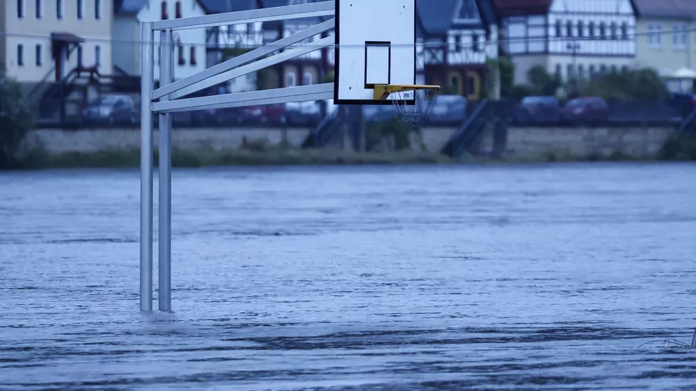 A basketball hoop stands in the flood waters of the Elbe in Bad Schandau, Germany Monday, Sept. 16, 2024. (Jan Woitas/dpa via AP)