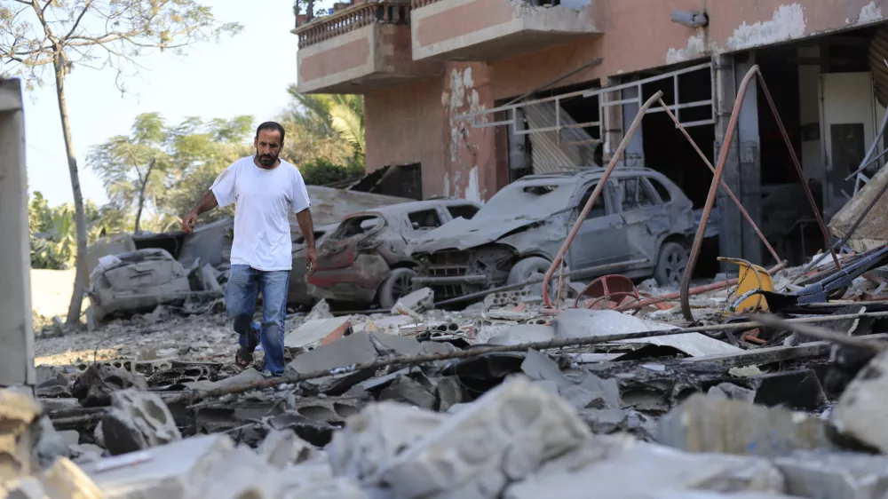 A man checks the damage to a building hit in an Israeli airstrike in the southern village of Akbieh, Lebanon, Tuesday, Sept. 24, 2024. (AP Photo/Mohammed Zaatari)