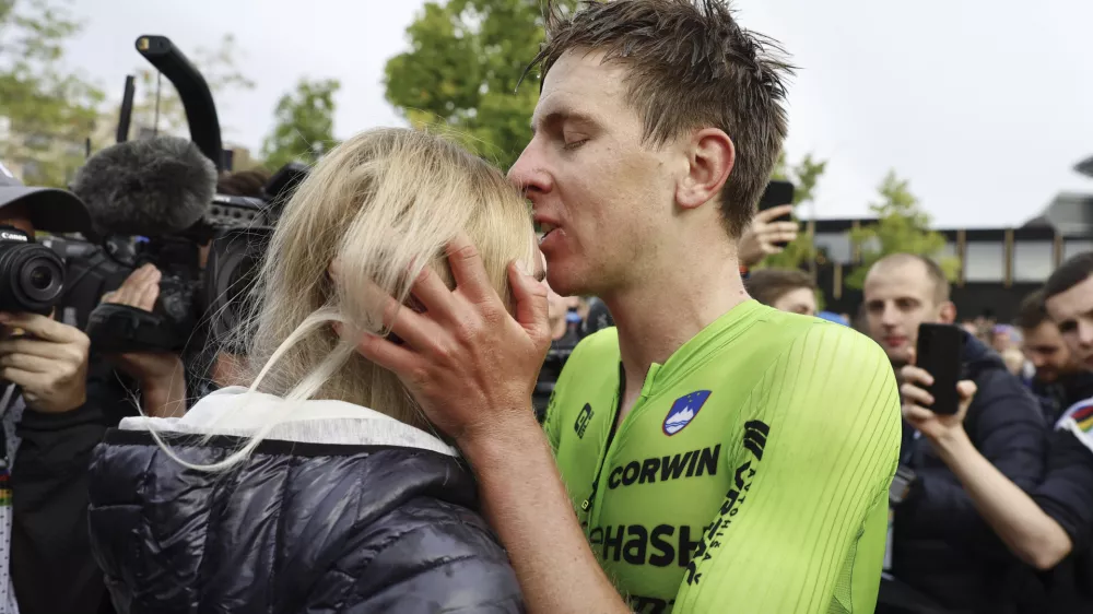 Slovenia's Tadej Pogacar kisses his girlfriend Urska Zigar after winning the Men Elite road race of the Cycling and Para-cycling Road World Championships in Zurich, Switzerland, Sunday, Sept. 29, 2024. (Michael Buholzer/Keystone via AP)