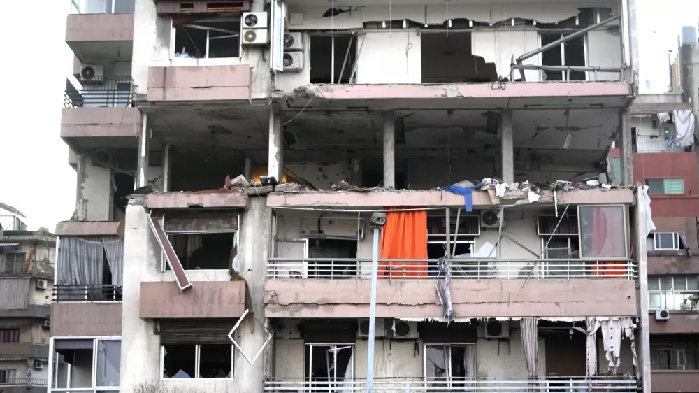 Damages are seen on a building that was hit by Israeli strike, early Monday, Sept. 30, 2024. (AP Photo/Hussein Malla)