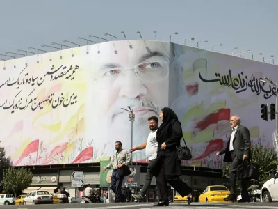People walk past a billboard with a picture of the late Lebanon's Hezbollah leader Hassan&nbsp;Nasrallah, in a street in Tehran, Iran October 2, 2024. Majid Asgaripour/WANA (West Asia News Agency) via REUTERS ATTENTION EDITORS - THIS IMAGE HAS BEEN SUPPLIED BY A THIRD PARTY.