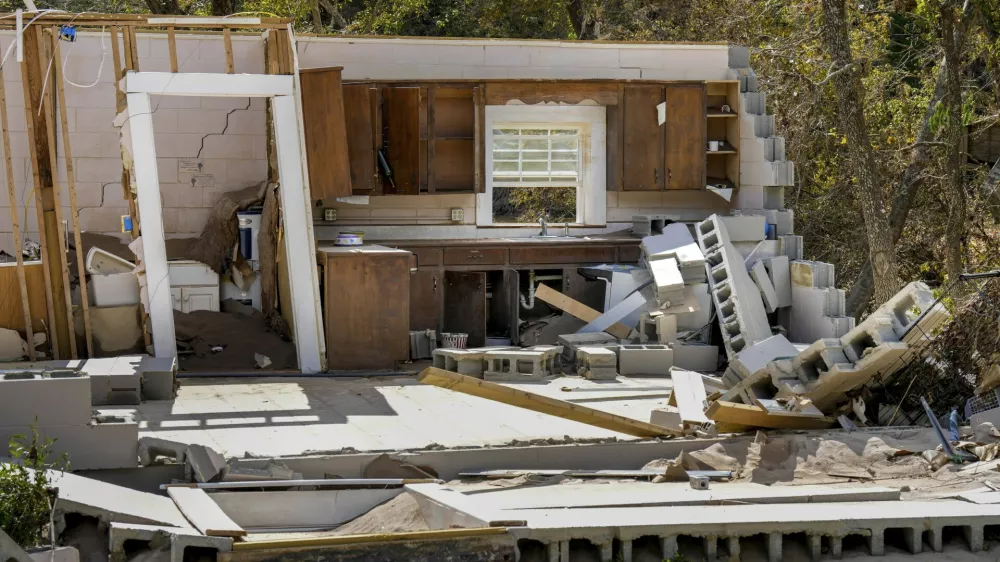 Damaged to one of the White family's homes that was destroyed by Hurricane Helene is seen, Tuesday, Oct. 1, 2024 in Morganton, N.C. The adjacent Catawba River flooded due to torrential rains destroying the seven of family's nine homes on the property. (AP Photo/Kathy Kmonicek)