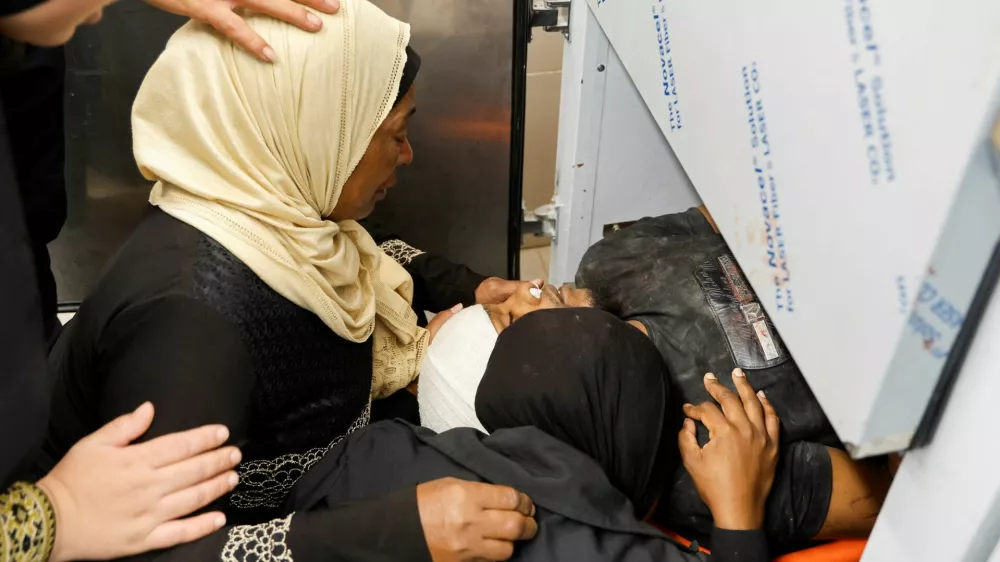 SENSITIVE MATERIAL. THIS IMAGE MAY OFFEND OR DISTURB People react next to the body of a Palestinian who was killed in an Israeli airstrike on the Tulkarm camp, at a morgue in a hospital, in Tulkarm, in the Israeli-occupied West Bank, October 4, 2024. REUTERS/Raneen Sawafta