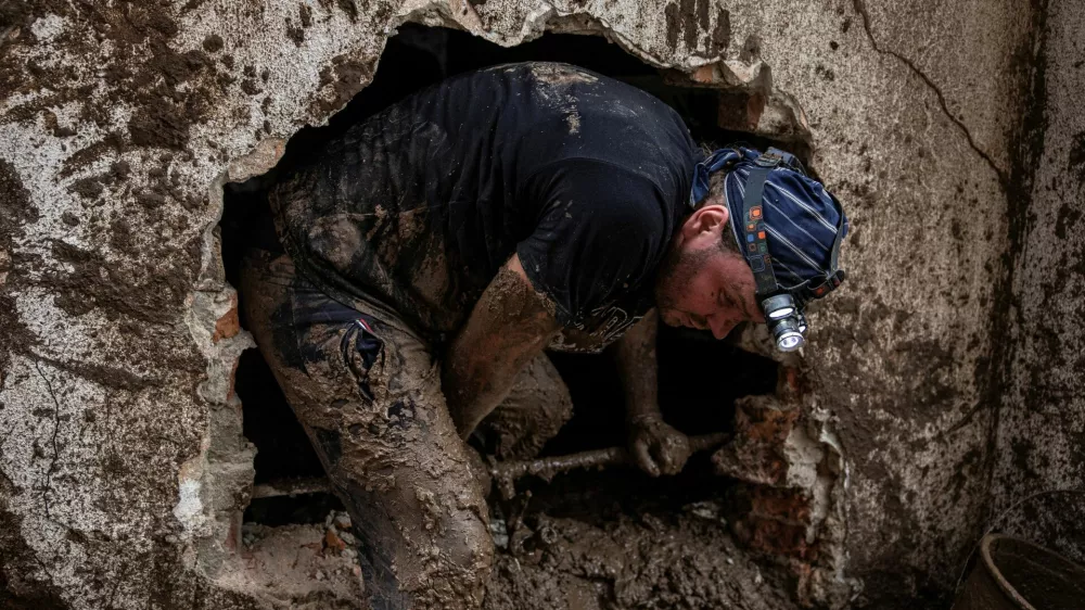 A man searches for victims following a landslide in the flooded village of Donja Jablanica, Bosnia and Herzegovina, October 5, 2024. REUTERS/Marko Djurica