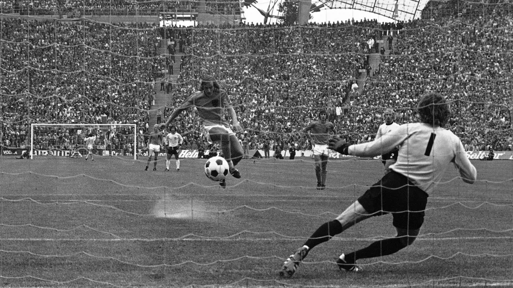FILE - Johan Neeskens of the Netherlands scores from the penalty spot past West Germany's Sepp Maier to give his team a 1-0 lead in the World Cup final soccer match in Munich, West Germany, July 7, 1974. (AP Photo, File)