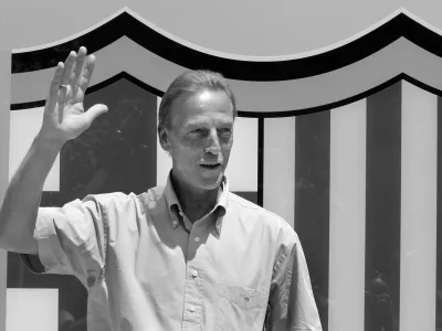 FILE PHOTO: Former Dutch international Johan Neeskens waves in front of Barcelona's badge after his arrival at Nou Camp stadium On June 13, 2006 as assistant to coach Frank Rijkaard. REUTERS/Gustau Nacarino/File Photo