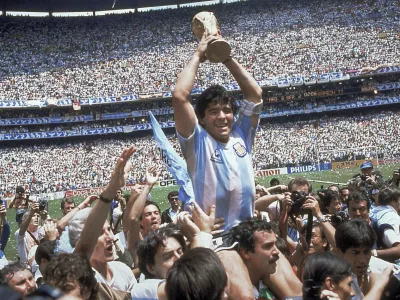 FILE - In this June 29, 1986, file photo, Diego Maradona holds up his team's trophy after Argentina's 3-2 victory over West Germany at the World Cup final soccer match at Azteca Stadium in Mexico City. The Argentine soccer great who was among the best players ever and who led his country to the 1986 World Cup title died from a heart attack on Wednesday, Nov. 25, 2020, at his home in Buenos Aires. He was 60. (AP Photo/Carlo Fumagalli, File)