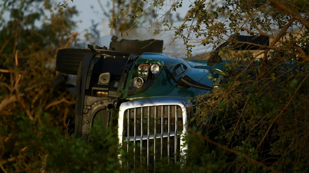 A vehicle lies on its side, after Hurricane Milton made landfall, in Lakewood Park, near Fort Pierce, in St. Lucie County, Florida, U.S., October 10, 2024. REUTERS/Jose Luis Gonzalez