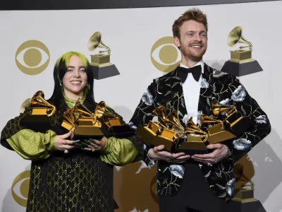 Billie Eilish, left, and Finneas O'Connell pose in the press room with the awards for best album, best engineered album and best pop vocal album for "We All Fall Asleep, Where Do We Go?," best song and record for "Bad Guy," best new artist and best producer, non-classical at the 62nd annual Grammy Awards at the Staples Center on Sunday, Jan. 26, 2020, in Los Angeles. (AP Photo/Chris Pizzello)